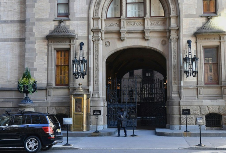 An employee stands outside The Dakota apartment building's gates on December 3, 2020, where John Lennon was shot dead on December 8, 1980, in New York City