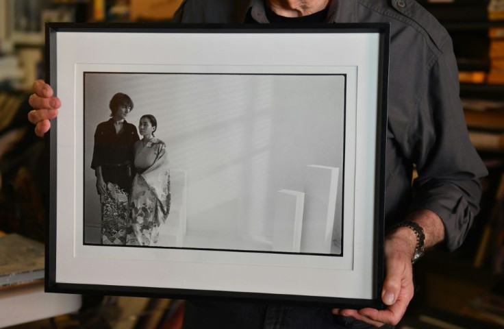 Photographer Allan Tannenbaum holds up a photograph he took of John Lennon and Yoko Ono in Manhattan
