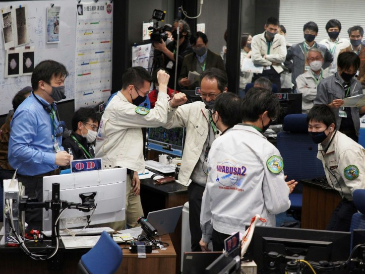 Officials from Japan's space agency JAXA cheered and pumped their fists in excitement after asteroid samples were dropped off on Earth by the Japanese space probe Hayabusa-2 (Photo source: JAXA)