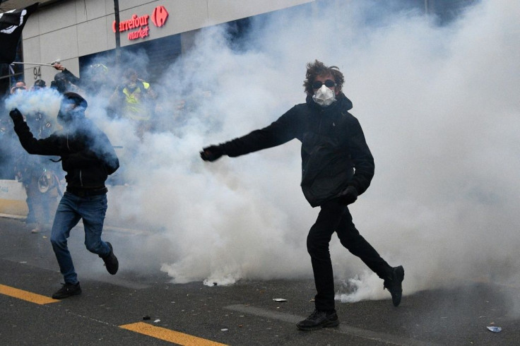 Protesters, surrounded by smoke of tear gas, clashed with police near the Paris Place de la Republique
