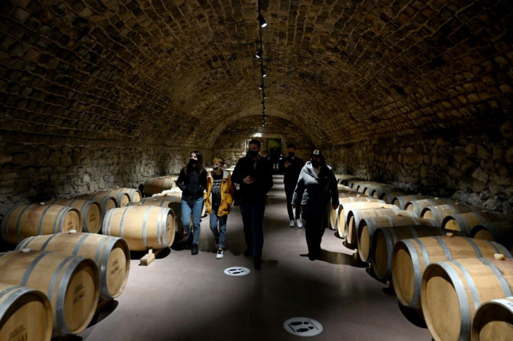 A group of tourists enjoy wandering the endless labyrinthine cellars at Cricova, which produces some 11 million bottles annually