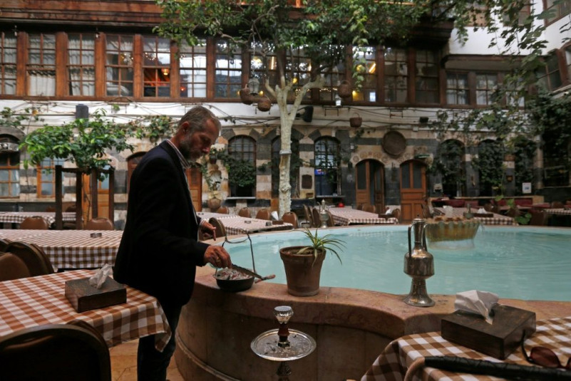 Raed al-Jabri works inside his home-turned-restaurant in Damascus