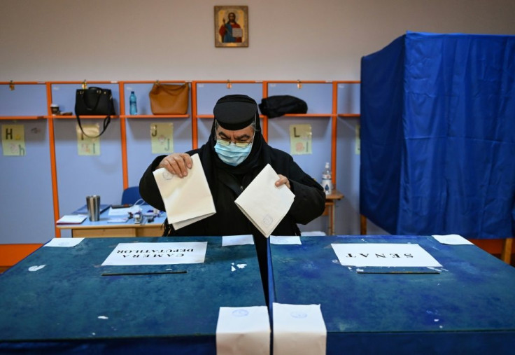 An Orthodox nun casts her ballots at a polling station in Pasarea, southern Romania, during the parliamentary elections on Sunday 2020. The ruling pro-European liberals have drawn fire for their handling of the novel coronavirus and economic crisis