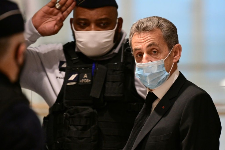 Former French president Nicolas Sarkozy (R) arrives for a hearing of his trial on corruption charges on December 7, 2020 at Paris' courthouse. Prosecutors say Sarkozy promised the judge a plush job in Monaco in exchange for inside information on a separat
