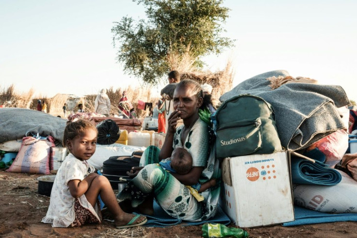 An Ethiopian family sit next to their belongings at Um Raquba refugee camp in eastern Sudan