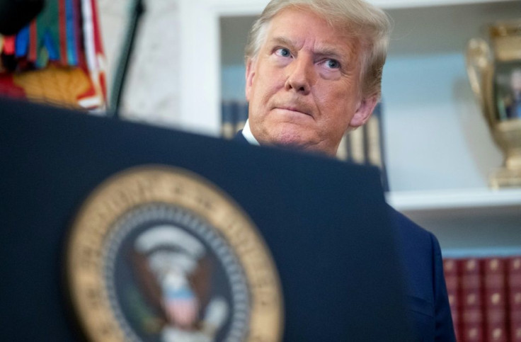 US President Donald Trump looks on during a ceremony presenting the Presidential Medal of Freedom to wrestler Dan Gable in the Oval Office of the White House in Washington, DC on December 7, 2020