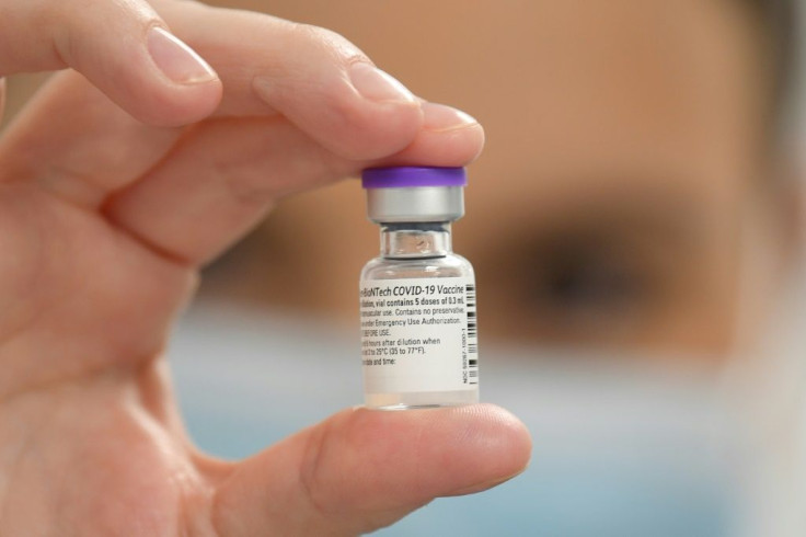 A member of staff poses with the Pfizer-BioNTech Covid-19 vaccine at a vaccination health centre in Cardiff, South Wales' on December 8, 2020