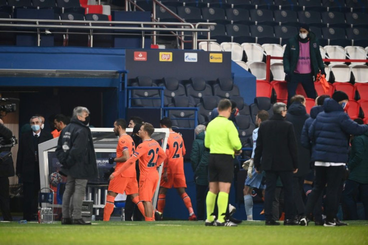 Istanbul Basaksehir players walk off the pitch at the Parc des Princes as their Champions League game with PSG was suspended over allegations of racism by one of the match officials