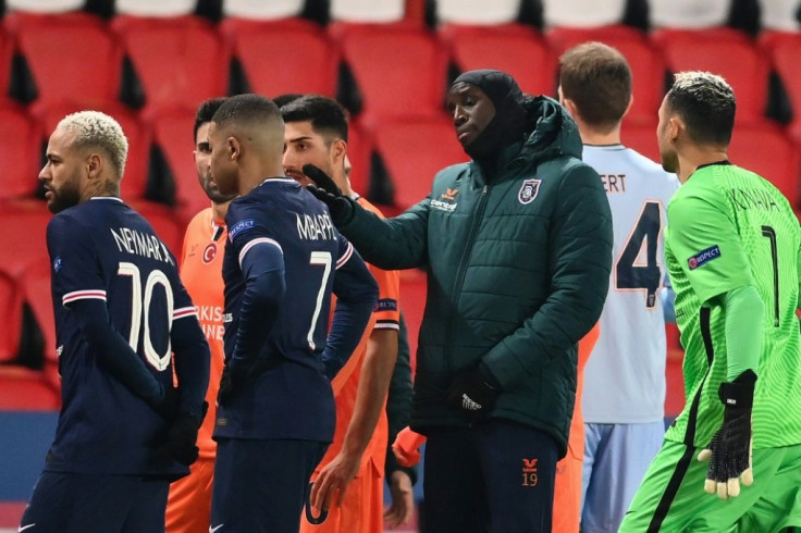 Istanbul Basaksehir forward Demba Ba remonstrates with officials as Paris Saint-Germain stars Neymar and Kylian Mbappe look on
