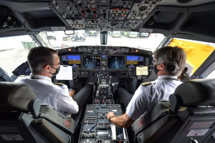 Pilots are pictured in the cockpit of a Boeing 737 MAX aircraft operated by low-cost airline Gol as it sits on the tarmac before take off at Guarulhos International Airport, near Sao Paulo on December 9, 2020, as the 737 MAX returns into use more than 20