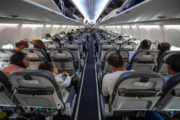 Passengers take their seats before take off in a Boeing 737 MAX aircraft operated by low-cost airline Gol at Guarulhos International Airport, near Sao Paulo on December 9, 2020, as the 737 MAX returns into use more than 20 months after it was grounded fol