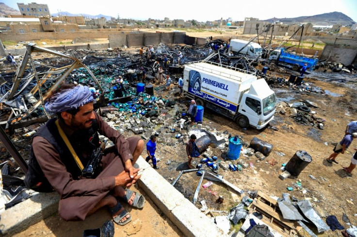 Workers search through debris at a warehouse after it was reportedly hit in an airstrike by the Saudi-led coalition in the Yemeni capital Sanaa in July 2020