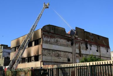 Firefighters put out the fire in the Spanish warehouse where up to 200 migrants lived