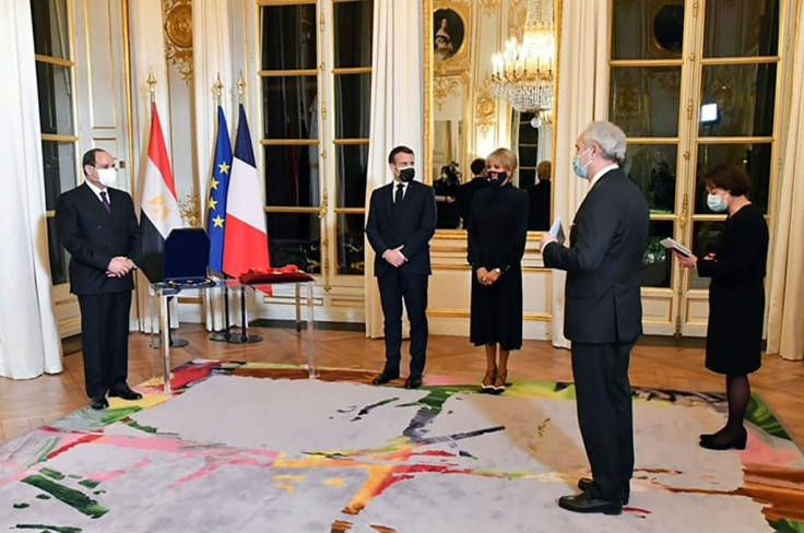 This picture, released by the Egyptian presidency, shows President Abdel Fattah al-Sisi receiving the Legion d'Honneur at the Elysee Palace.