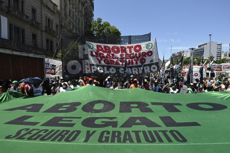 Pro-abortion activists demonstrate with a banner reading âLegal abortion, safe and freeâ, outside the Argentine Congress in Buenos Aires, on December 10, 2020