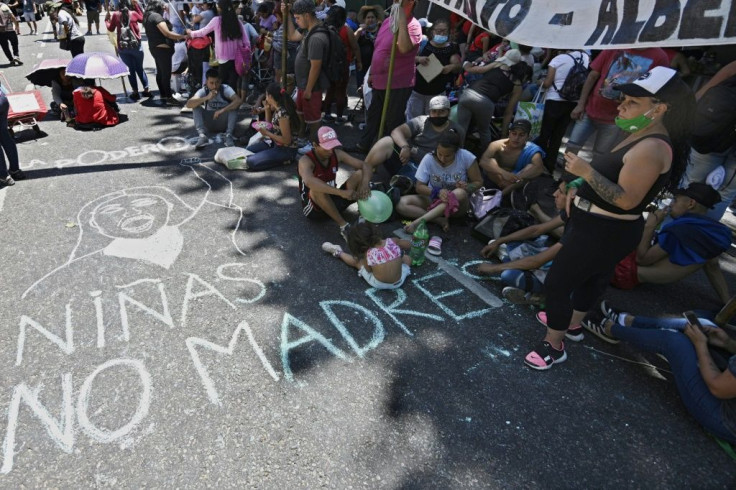 Pro-abortion activists demonstrate next to a sign written on the pavement reading âGirls not mothersâ outside the Argentine Congress in Buenos Aires, on December 10, 2020