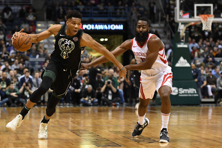 Giannis Antetokounmpo #34 of the Milwaukee Bucks drives around James Harden #13 of the Houston Rockets