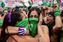 Women in green scarves celebrate outside the Argentine Congress after the lower house passed a bill to legalize abortion