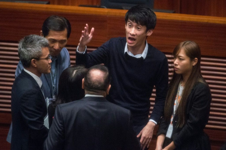 Former Hong Kong lawmaker Sixtus Leung (pictured with hand raised during a protest at the Legislative Council in 2016) says he is seeking asylum in the United States