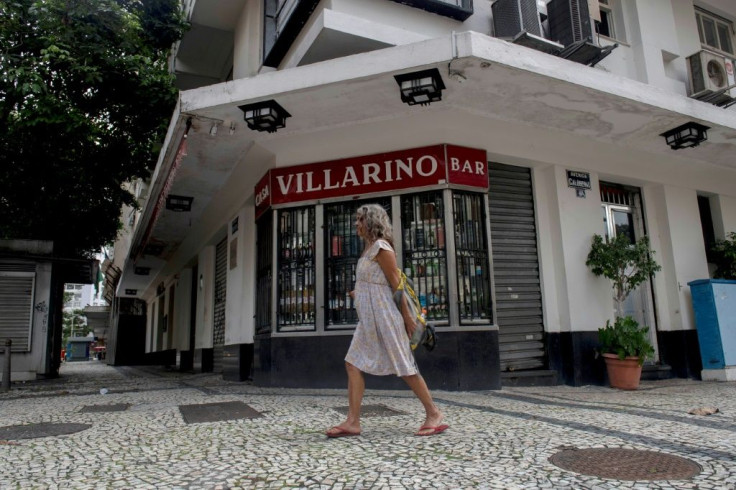 A woman walks past the closed Casa Villarino, a famed bar that closed because of the coronavirus pandemic in Rio de Janeiro, Brazil, on December 08, 2020