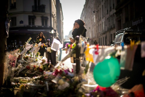 A woman cries at a makeshift memorial to the victims of a series of deadly attacks in Paris in November 2015