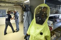 A man tries on an air permeable charcoal impregnated suit during a simulation at OPCW headquarters in The Hague, The Netherlands, on April 20, 2017