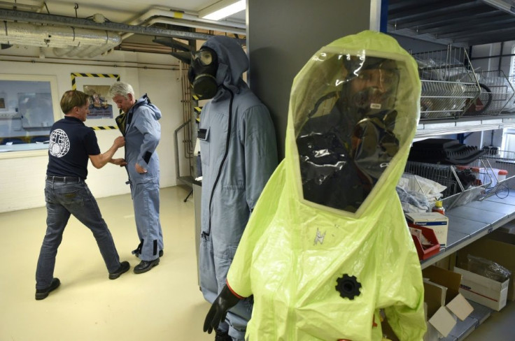 A man tries on an air permeable charcoal impregnated suit during a simulation at OPCW headquarters in The Hague, The Netherlands, on April 20, 2017