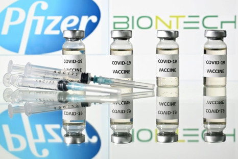 Vials with Covid-19 Vaccine stickers attached and syringes with the logo of US pharmaceutical company Pfizer and German partner BioNTech