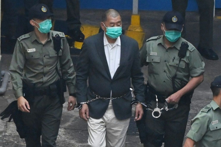 Jimmy Lai is led to a police van as he heads to court