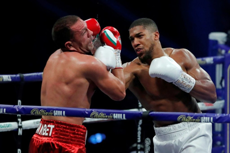 Knockout: Anthony Joshua (right) knocked out Bulgaria's Kubrat Pulev (left)to retain his three world heavyweight titles on Saturday
