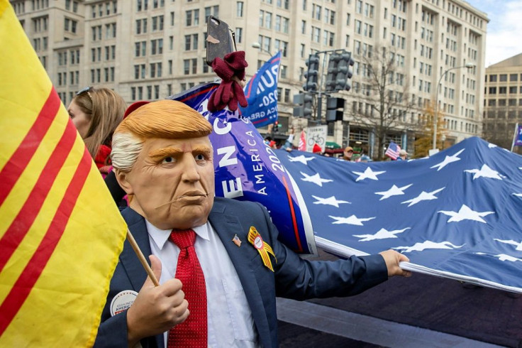 Protesters, including some in Donald Trump masks, marched in Washington on December 12, 2020 to protest Joe Biden's victory in the November election and to insist Trump lost only because of widespread fraud