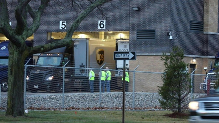 UPS and FedEx trucks transporting Pfizer-BioNTech vaccines against Covid-19 leave Pfizer's Global Supply facility in Kalamazoo, Michigan