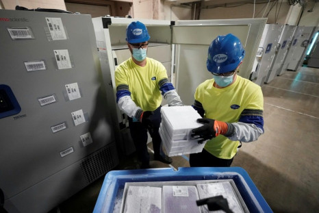 Boxes containing the Pfizer-BioNTech Covid-19 vaccine are prepared to be shipped at the Pfizer plant in Kalamazoo, Michigan