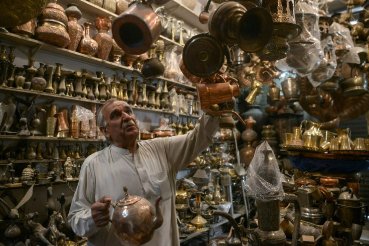 Khwaja Safar Ali, 75, arranges items in his antiques shop at the oldest Qissa Khawani or "storytellers bazaar" in Pakistan's northwestern city of Peshawar