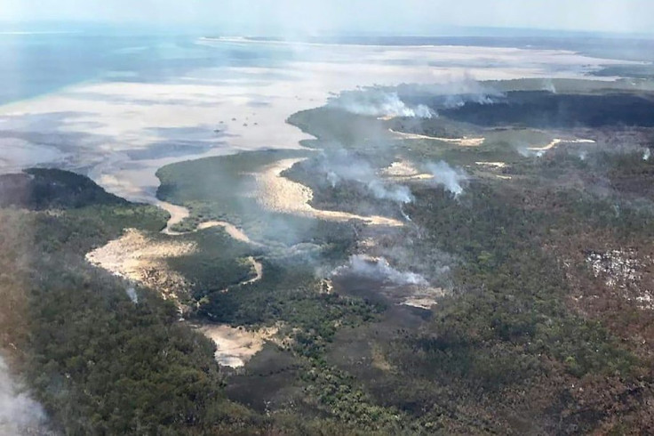 Bushfires that have burned more than half of UNESCO world heritage-listed Fraser Island are suspected to have been started by an illegal campfire