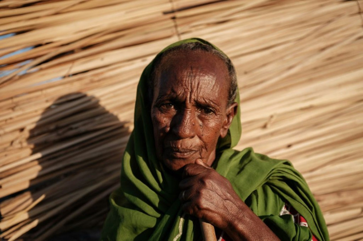 Ethiopian Jeshu Walagarima, a 75-year-old who fled the Tigray conflict with her grandsons, outside her makeshift shelter at the Um Raquba refugee camp