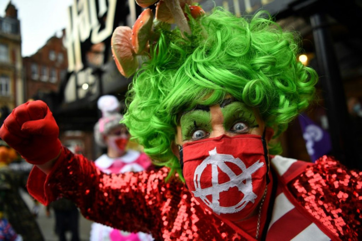 Britain's traditional pantomime dames, male actors in garish female costumes, took part in a protest march to the Houses of Parliament in London in September to highlight the impact the pandemic is having on live theatre