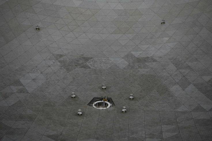 Workers are seen at the Five-hundred-meter Aperture Spherical radio Telescope (FAST) during maintenance work