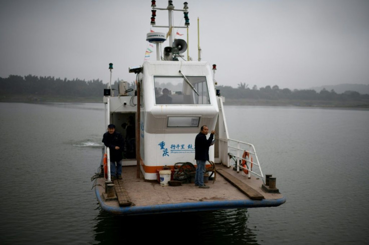 Yang Zeqiang's boat arrives at shore opposite Zhongba, a small island near the southwestern city of Chongqing