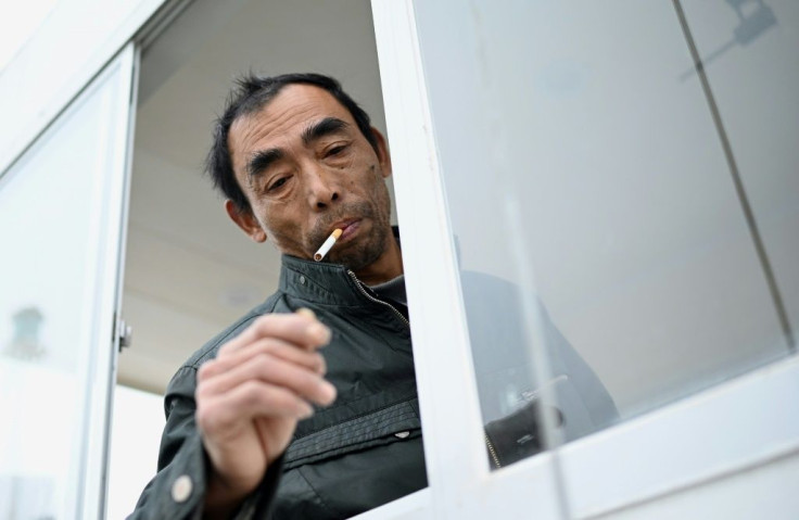 Former fisherman Yang Zeqiang at the helm of his boat near Zhongba