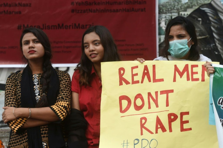 A demonstrator holds a placard next to others during a protest against an alleged gang rape of a woman, in Karachi, Pakistan on September 18, 2020