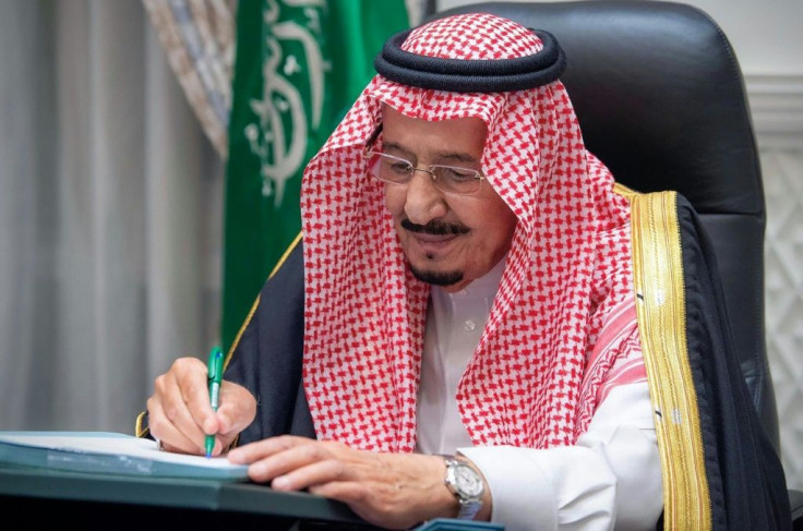 Saudi Arabia's King Salman bin Abdulaziz signs the 2021 state budget following a virtual cabinet meeting in the capital Riyadh