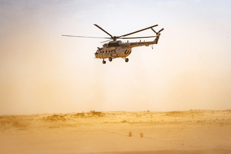 A helicopter from the UN Mission for the Referendum in Western Sahara flies over the divided region on November 25; the force is mandated to hold a vote for self-determination to settle a decades old dispute