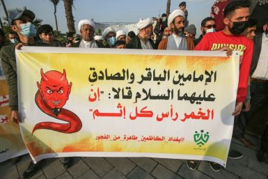 Shiite Muslim clerics from a group calling itself Tajammu' Shabab al-Sharia (Sharia Youth Rally) march with a banner quoting Shiite Imams Baqir and Sadiq as saying that alcohol is the root of all sin, during a demonstration in Baghdad this month