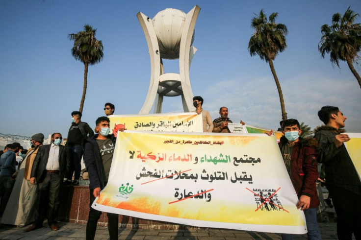 Youths from a group calling itself Tajammu' Shabab al-Sharia (Sharia Youth Rally) hold up a banner condemning liquor stores and brothels, during a demonstration in the Iraqi capital this month