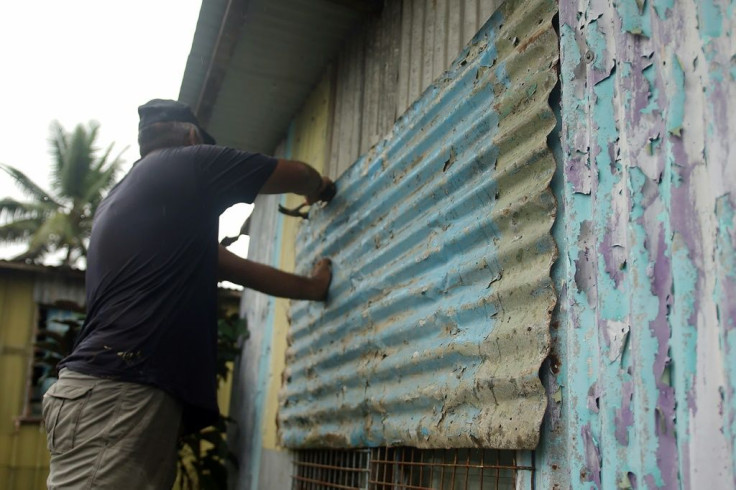 A resident secures his house by placing steel sheets on the windows in Fiji's capital Suva on December 16, 2020, ahead of super cyclone Yasa