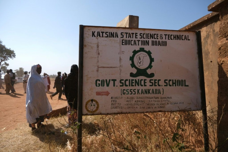 Parents wait outside the Government Science secondary school in Kankara, where hundreds of pupils were abducted