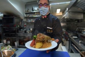 Tunisian chef Taieb Bouhadra presents a traditional Tunisian lamb couscous dish at a restaurant in the capital Tunis