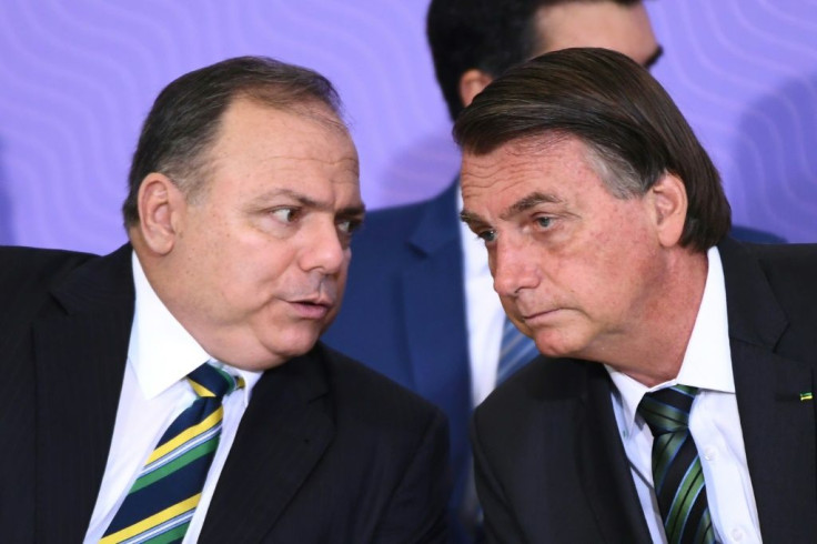 Brazilian President Jair Bolsonaro (R) listens to his Health Minister Eduardo Pazuello, during the launch of the national vaccination plan against Covid-19 at Planalto Palace in Brasilia, on December 16, 2020