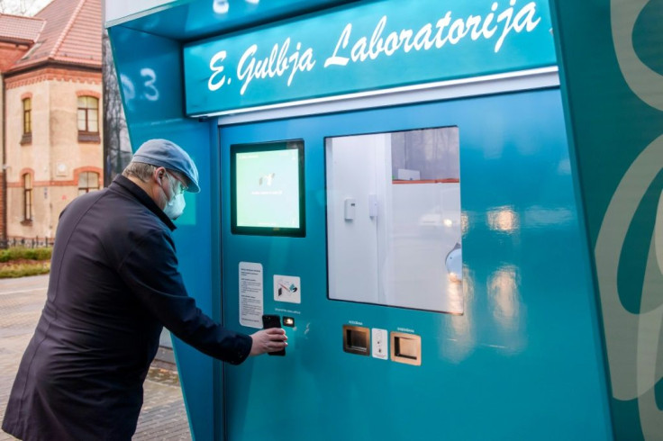 The automated centre hands out testing kits with a robot arm and then collects the samples